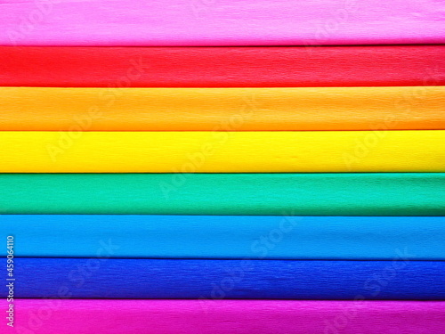Pride Flag by Gilbert Baker. Symbol of the overall LGBTQ LGBTI community. Crepe paper is available in pink, red, orange, yellow, crepe, blue, purple and magenta. Colorful background for Pride events