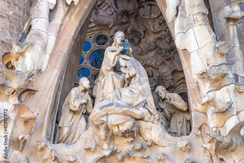 Detail of the coronation of the Virgin Mary in the facade of sacred family "La Sagrada Familia" , cathedral designed by Gaudi, being built since 19 March 1882 with people donations