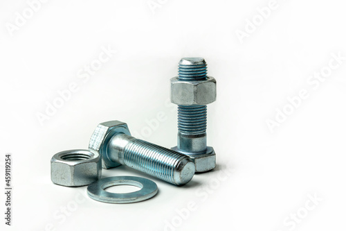 several large bolts and nuts on a white background