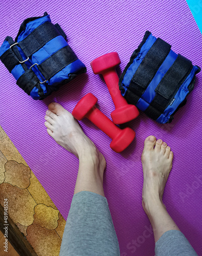 Equipment for exercising the muscles of the arms and legs. Weights, sandbags and female legs