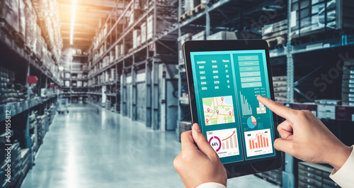 Warehouse management innovative software in computer for real time monitoring of goods package delivery . Computer screen showing smart inventory dashboard for storage and supply chain distribution .