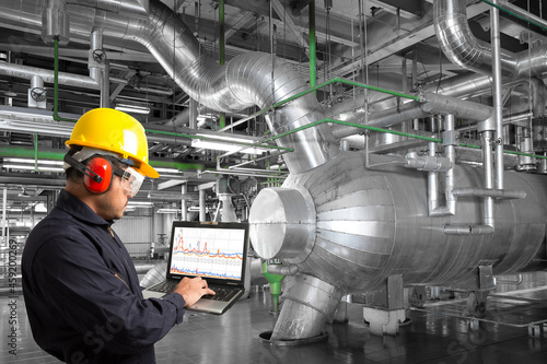 Engineer use computer check for maintenance equipment and pipeline in a modern thermal power plant industrial