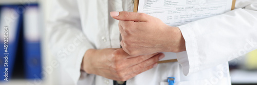 Doctor holds clipboard with the patient medical history