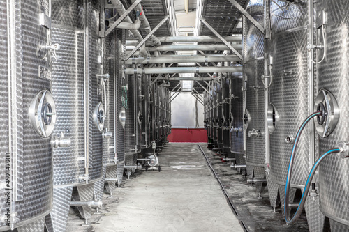 Steel wine tanks for wine fermentation at a winery. modern wine factory with large shine tanks for the fermentation.