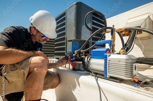 HVAC technician repairing an air conditioner