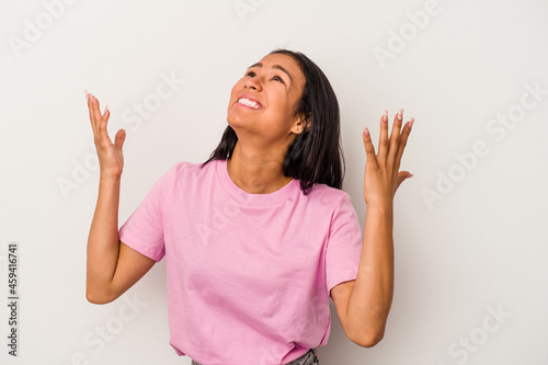 Young latin woman isolated on white background screaming to the sky, looking up, frustrated.
