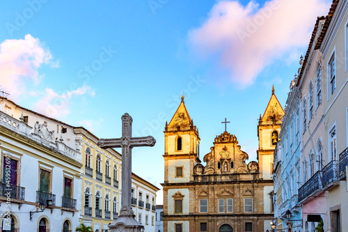 Old houses and churches in colonial and baroque style with a crucifix in the central square of the historic Pelourinho district in Salvador, Bahia