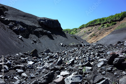 Big dark ash canyon after post-eruptive lahar flow on mountainside of Villarrica volcano, Villarrica national park in Chile, South America nature landscape