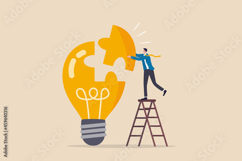 Solve business problem with creativity, finishing or complete brilliant idea, work solution or business idea concept, smart businessman assemble last piece of jigsaw to complete lightbulb idea puzzle.