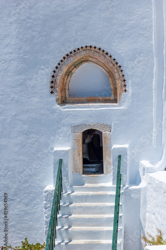 The entrance of the famous Hozoviotissa Monastery that stands on a rock over the Aegean sea in Amorgos island, Cyclades, Greece.