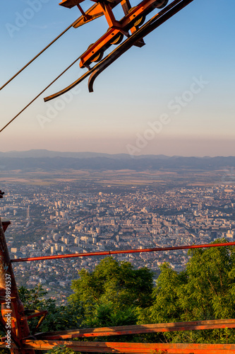 Blue hour elevated view of Sofia, the capital of Bulgaria, from nearby the old rusty out of order cable car at Kopitoto peak, Vitosha mountain