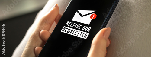 Banner, mobile phone with newsletter signup page close-up in woman hands. Email marketing or newsletter concept, sending e-mails concept