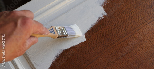 a brown kitchen cabinet is painted with white chalk paint