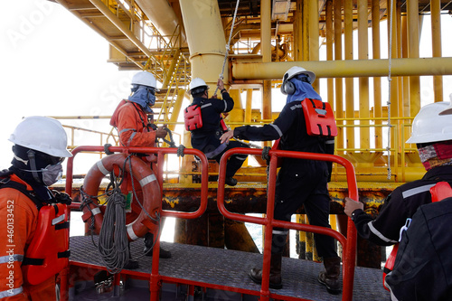 Construction crews are swing rope for transferred by crew boat to oil and gas platform