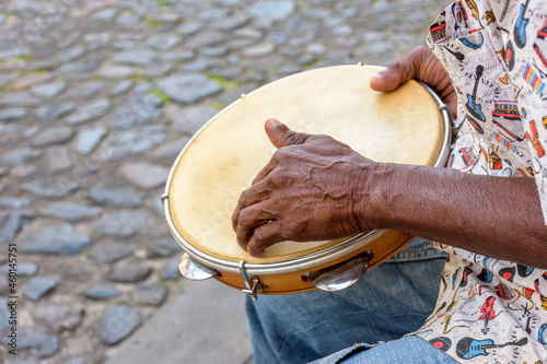 Brazilian samba performance with musician playing tambourine in the streets of Pelourinho, city of Salvador, Bahia