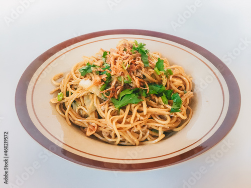 Mie Goreng Jawa or bakmi jawa or java noodle. Indonesian traditional street food noodles from central java or Yogyakarta, indonesia on white background.