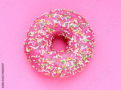 Donut with a pink icing on a pink background