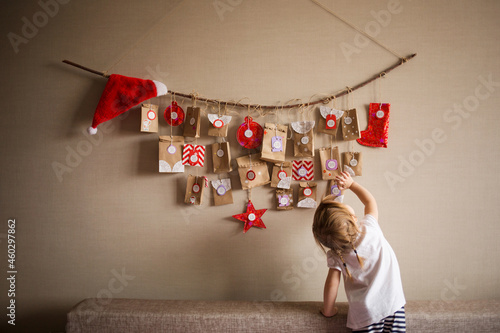 advent calendar for kid is hanging on table. children christmas concept