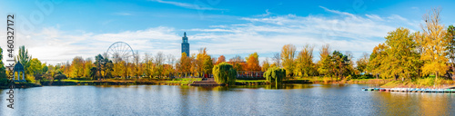 Panoramic view over city park Rotehorn and lake in Autumn colors at sunny day with blue sky, Magdeburg, Germany.