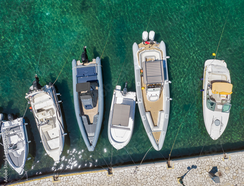 Motor boats moored in old port of Kassiopi, Corfu, Greece.