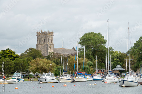 view of Christchurch Priory from across the River Stour Dorset England