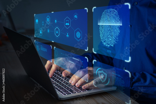 Fingerprint scan for secure access to protected data network with biometrics. Person using finger print authentication technology on laptop computer to login on private system.