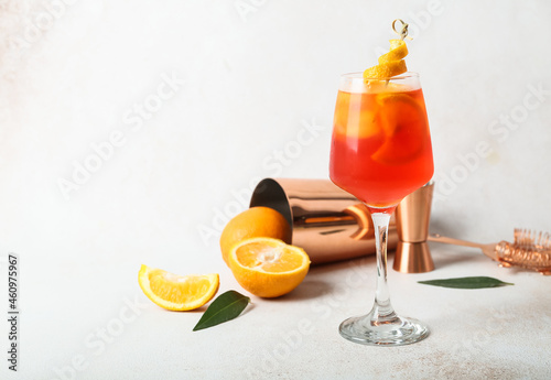 Glass of Aperol spritz cocktail on light background