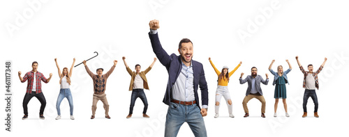 Cheerful young man gesturing happiness and other people behind raising arms