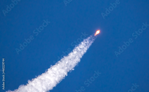 A real Soyuz in flight, a launch vehicle from the Baikonur Cosmodrome. Rocket take off in the sky against the background of clouds. Startup concept, power of science and technology.