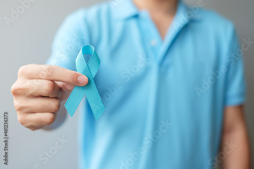 November Prostate Cancer Awareness month, Man in blue shirt with hand holding Blue Ribbon for supporting people living and illness. Healthcare, International men, Father and World cancer day concept