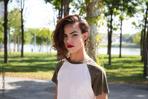 young latina transsexual woman is in a park where she is going to start doing her make-up for her big change from boy to girl. Concept of diversity, transgender, and freedom of homosexual expression.