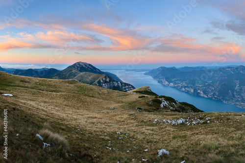 Colorful sky at sunrise at lake garda from top of monte baldo, monte altissimo