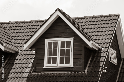 pitched roof dormer loft with white window and concrete tiles