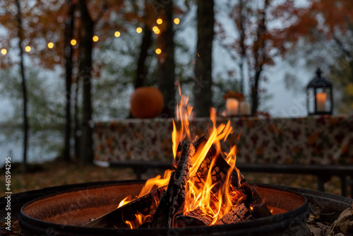 Glowing camp fire at autumn campsite