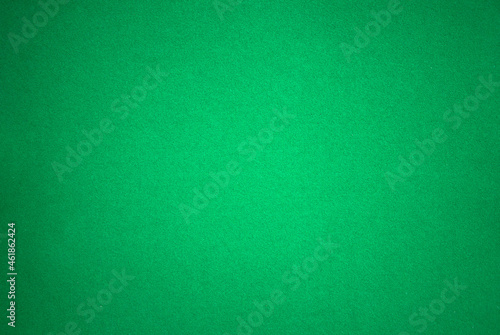 Texture of green cardboard with soft pile. Green background for text.Photo of a cardboard sheet of paper.