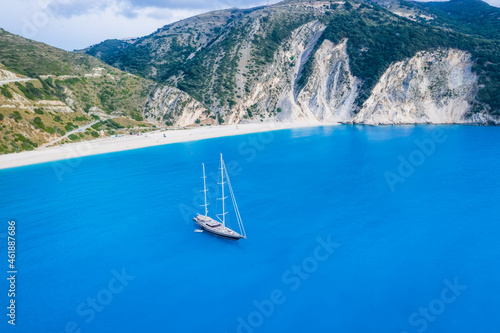 Aerial view of Luxury Sail Yacht in Myrtos beach with blue bay on Kefalonia Island, Greece