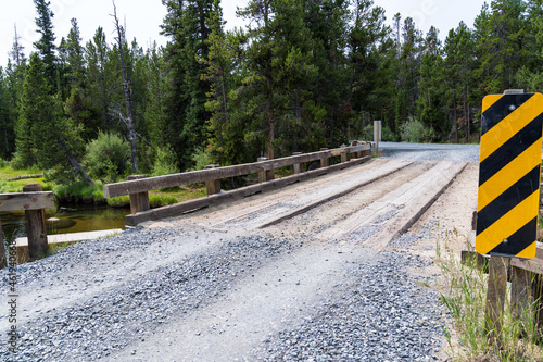 Newly graded gravel road over a bridge spanning the Little Popo Agie River outside of Lander, Wyoming