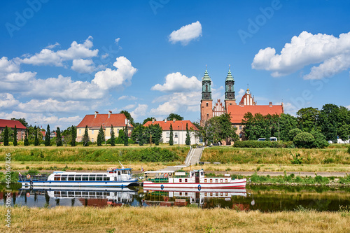 Cruise ships on the Warta River and the bell towers of the historic cathedral