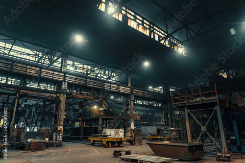 Large metallurgical factory workshop interior and machines.