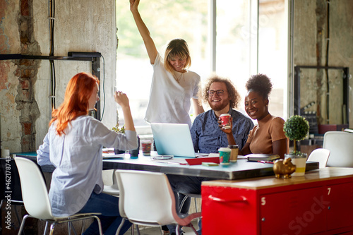 Group of young colleagues are working in a pleasant atmosphere in the office together