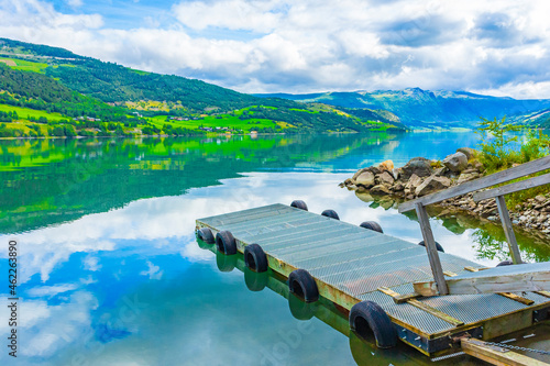 Jetty at amazing norwegian landscape mountains fjord forests Jotunheimen Norway.