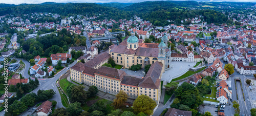 Aerial around the city and monastery Weingarten in Germany on a cloudy day in summer