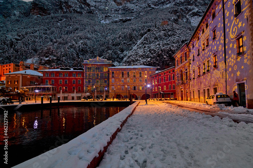 Christmas lights adorning the city center and Riva del Garda with snowy streets,View of the beautiful Riva del Garda town by night,Italy