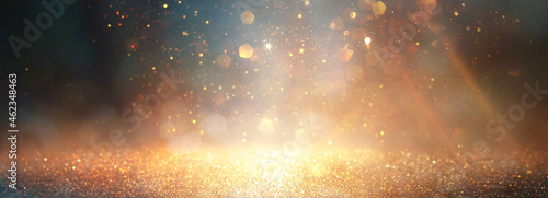 background of abstract glitter lights. gold, blue and black. de focused