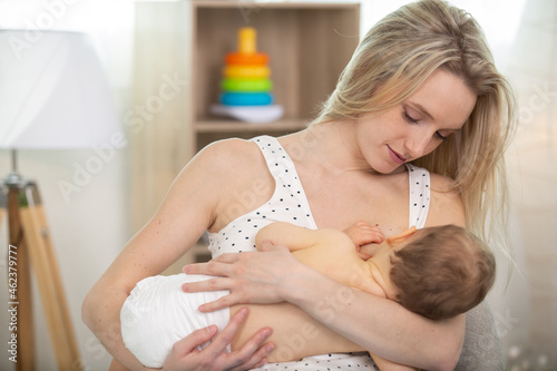 a mother is breastfeeding baby