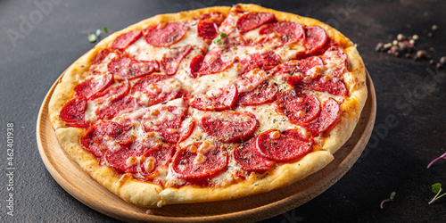 Pizza salami fast food pepperoni sausage, cheese, tomato sauce, dough fresh meal snack on the table copy space food background rustic 