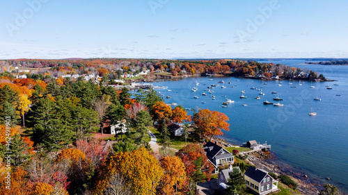 Aerial view of maine coastal harbor - drone picture of lobster boats with the ocean inside a marina sunset - kennebunk maine round pond maine coastal maine