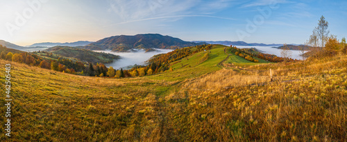 Morning foggy clouds in autumn mountain countryside. Ukraine, Carpathian Mountains, Transcarpathia. Peaceful picturesque traveling, seasonal, nature and countryside beauty concept scene.