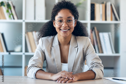 Elegant business woman listening while doing video call in a modern start up.