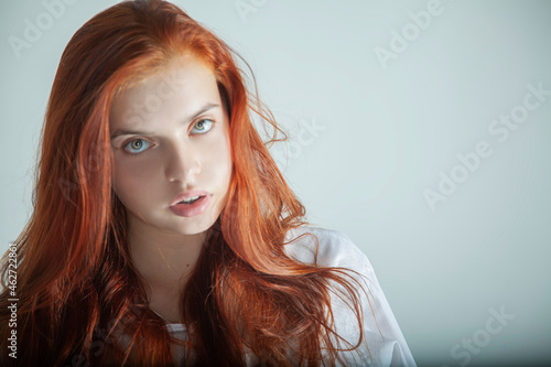 Closeup portrait of a girl with red hair beauty model fashion pretty face cute hairstyle white lifestyle elegance